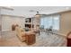 Inviting living room features a ceiling fan, wood-look floors, and backyard views through sheer window coverings at 4625 W Robindale Rd, Las Vegas, NV 89139