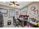 Comfortable home office with dark wood desk, ample shelving, and natural light from the window at 4625 W Robindale Rd, Las Vegas, NV 89139
