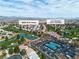 An aerial view of the community with lush landscaping, a pond, golf course, and tennis courts at 5209 Rim View Ln, Las Vegas, NV 89130