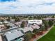 Aerial view of a residential community with lush landscaping, tile roofs, and a golf course and mountain views at 5209 Rim View Ln, Las Vegas, NV 89130