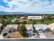 Aerial view of the home and neighborhood with well-maintained lawns and lush green landscaping at 5209 Rim View Ln, Las Vegas, NV 89130