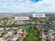 Bright aerial view of a house and the Los Prados golf course community at 5209 Rim View Ln, Las Vegas, NV 89130