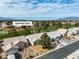 Aerial view of a residential community with tile roofs, mature trees, and lush landscaping with mountain views at 5209 Rim View Ln, Las Vegas, NV 89130