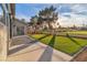 Manicured backyard features a lush lawn, patio, and outdoor seating area at 5209 Rim View Ln, Las Vegas, NV 89130