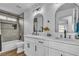 Well-lit bathroom features a double sink vanity with modern black fixtures and a tiled shower-tub combo at 5209 Rim View Ln, Las Vegas, NV 89130