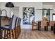 Modern open-concept dining area with sleek barstool seating adjacent to the dining table with seating at 5209 Rim View Ln, Las Vegas, NV 89130