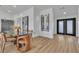 Dining room with a modern glass table, chairs, and stylish wine rack at 5209 Rim View Ln, Las Vegas, NV 89130