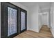 Elegant double front door with decorative glass panels, leading to a bright hallway with wood-look floors at 5209 Rim View Ln, Las Vegas, NV 89130