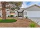 Welcoming single-story home with desert landscaping, a mature tree, and a double-door entry at 5209 Rim View Ln, Las Vegas, NV 89130