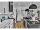 Modern kitchen featuring white countertops, black accents, stainless steel appliances, and ample storage at 5209 Rim View Ln, Las Vegas, NV 89130