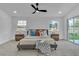 Bright main bedroom with a ceiling fan, bedside tables, and access to the outdoor patio at 5209 Rim View Ln, Las Vegas, NV 89130