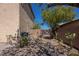 Desert landscaping defines this backyard space with a view of the gate at 53 Hoke Edward Ct, North Las Vegas, NV 89031