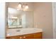 Bathroom featuring an expansive mirror and a sink with wood cabinets at 53 Hoke Edward Ct, North Las Vegas, NV 89031