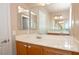 Bathroom featuring an expansive mirror and wood cabinets at 53 Hoke Edward Ct, North Las Vegas, NV 89031