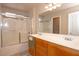 Bathroom with double sinks, wood cabinets, and glass door shower at 53 Hoke Edward Ct, North Las Vegas, NV 89031