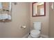 Small half bathroom featuring a toilet, mirror, and towel rack at 53 Hoke Edward Ct, North Las Vegas, NV 89031