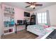 Bright bedroom with light pink walls, wood floors, a ceiling fan, and a workstation at 53 Hoke Edward Ct, North Las Vegas, NV 89031