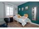 Bedroom with hardwood floors, natural light, a desk, and a green accent wall at 53 Hoke Edward Ct, North Las Vegas, NV 89031