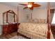 Cozy bedroom with a four-poster bed, floral bedding, and decorative ceiling fan at 53 Hoke Edward Ct, North Las Vegas, NV 89031