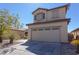 Two-story home featuring desert landscaping, neutral stucco, and a two-car garage, creating curb appeal at 53 Hoke Edward Ct, North Las Vegas, NV 89031