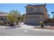 Two-story home featuring desert landscaping, neutral stucco, and a two-car garage, creating curb appeal at 53 Hoke Edward Ct, North Las Vegas, NV 89031