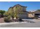 Two-story home featuring desert landscaping, neutral stucco, and a two-car garage, creating curb appeal at 53 Hoke Edward Ct, North Las Vegas, NV 89031