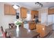 Cozy kitchen featuring wood cabinets, granite counters, stainless steel appliances, and an adjacent dining area at 53 Hoke Edward Ct, North Las Vegas, NV 89031