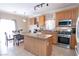 Eat-in kitchen features an island, stainless steel appliances, and tile flooring at 53 Hoke Edward Ct, North Las Vegas, NV 89031