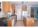 Well-lit kitchen with granite countertops, light wood cabinets, stainless steel appliances, and tile flooring at 53 Hoke Edward Ct, North Las Vegas, NV 89031