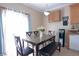 Bright kitchen and dining area with tile flooring and a view of the backyard at 53 Hoke Edward Ct, North Las Vegas, NV 89031