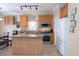 Well-equipped kitchen featuring tile floors, kitchen island, and stainless steel appliances at 53 Hoke Edward Ct, North Las Vegas, NV 89031