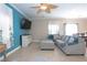 Spacious living room boasts sleek tile flooring, blue accent wall and ceiling fan at 53 Hoke Edward Ct, North Las Vegas, NV 89031