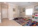 A living space with a cozy rocking chair, table, and view into the hallway and other living areas at 53 Hoke Edward Ct, North Las Vegas, NV 89031