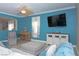 Relaxing living room showcasing a blue accent wall, large window and a ceiling fan at 53 Hoke Edward Ct, North Las Vegas, NV 89031