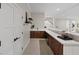 Elegant bar area showcasing dark wood cabinets, quartz countertops, and sleek fixtures at 541 Patti Ann Woods Dr, Henderson, NV 89002