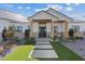 Charming single-story home featuring a stone accent wall, modern wood pillars, and a well-manicured lawn at 541 Patti Ann Woods Dr, Henderson, NV 89002