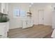 Bright laundry room featuring white cabinets, light wood floors, and a window with views at 541 Patti Ann Woods Dr, Henderson, NV 89002