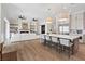 View of open floor plan kitchen, bar seating, living and dining room, with wood flooring at 541 Patti Ann Woods Dr, Henderson, NV 89002