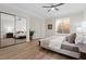 Serene bedroom featuring wood floors, a mirrored closet, and a cozy seating area at 541 Patti Ann Woods Dr, Henderson, NV 89002