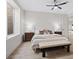 Bright bedroom featuring wood floors, a cozy bench, and a neutral color palette at 541 Patti Ann Woods Dr, Henderson, NV 89002