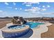 Stunning pool featuring a rock waterfall, spa, and covered outdoor dining area, perfect for entertaining at 541 Patti Ann Woods Dr, Henderson, NV 89002