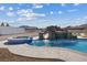 Backyard featuring pool with rock waterfall, hot tub, and water slide, perfect for outdoor fun at 541 Patti Ann Woods Dr, Henderson, NV 89002