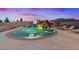 Swimming pool featuring a rock waterfall and luxurious lounge chairs, perfect for relaxation at 541 Patti Ann Woods Dr, Henderson, NV 89002