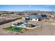 Aerial view of a backyard featuring a luxurious pool with rock features and a covered outdoor living space at 541 Patti Ann Woods Dr, Henderson, NV 89002