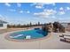 Gorgeous pool area with sun loungers, and a rock waterfall feature in the backyard at 541 Patti Ann Woods Dr, Henderson, NV 89002