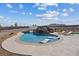 Beautiful backyard pool featuring a rock waterfall, spa, and stylish chaise lounges at 541 Patti Ann Woods Dr, Henderson, NV 89002