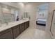 Bright bathroom with dual sinks, modern fixtures, and a glass-enclosed shower at 5528 Eleganza Ave, Pahrump, NV 89061