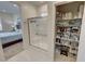 Bright bathroom featuring a glass shower and an organized linen closet for ample storage at 5528 Eleganza Ave, Pahrump, NV 89061