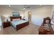 Bright bedroom featuring a ceiling fan, a comfortable king-size bed, and stylish wood furniture at 5528 Eleganza Ave, Pahrump, NV 89061