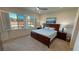 Bedroom with plantation shutters framing backyard views, and an inviting king-size bed at 5528 Eleganza Ave, Pahrump, NV 89061